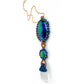 A side view of: Handcrafted Azure Key Amulet from the You Are The Key Collection, featuring Malachite, Azurite, Clear Quartz, Lapis, and Gold filled silver. A symbol of enlightened leadership and insight. Adorned with a 1.5mm snake chain, 20 inches. Includes a custom silk bag for safekeeping. Experience the essence of the Azure Key—a unique blend of gemstones for personal transformation