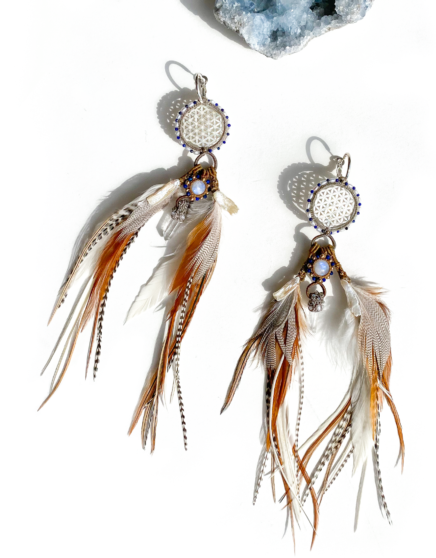 Feather Earrings on white background with Celestite Geode Crystal – featuring clear quartz, Lapis, pearl & gold, a unique symbol of love and intention.