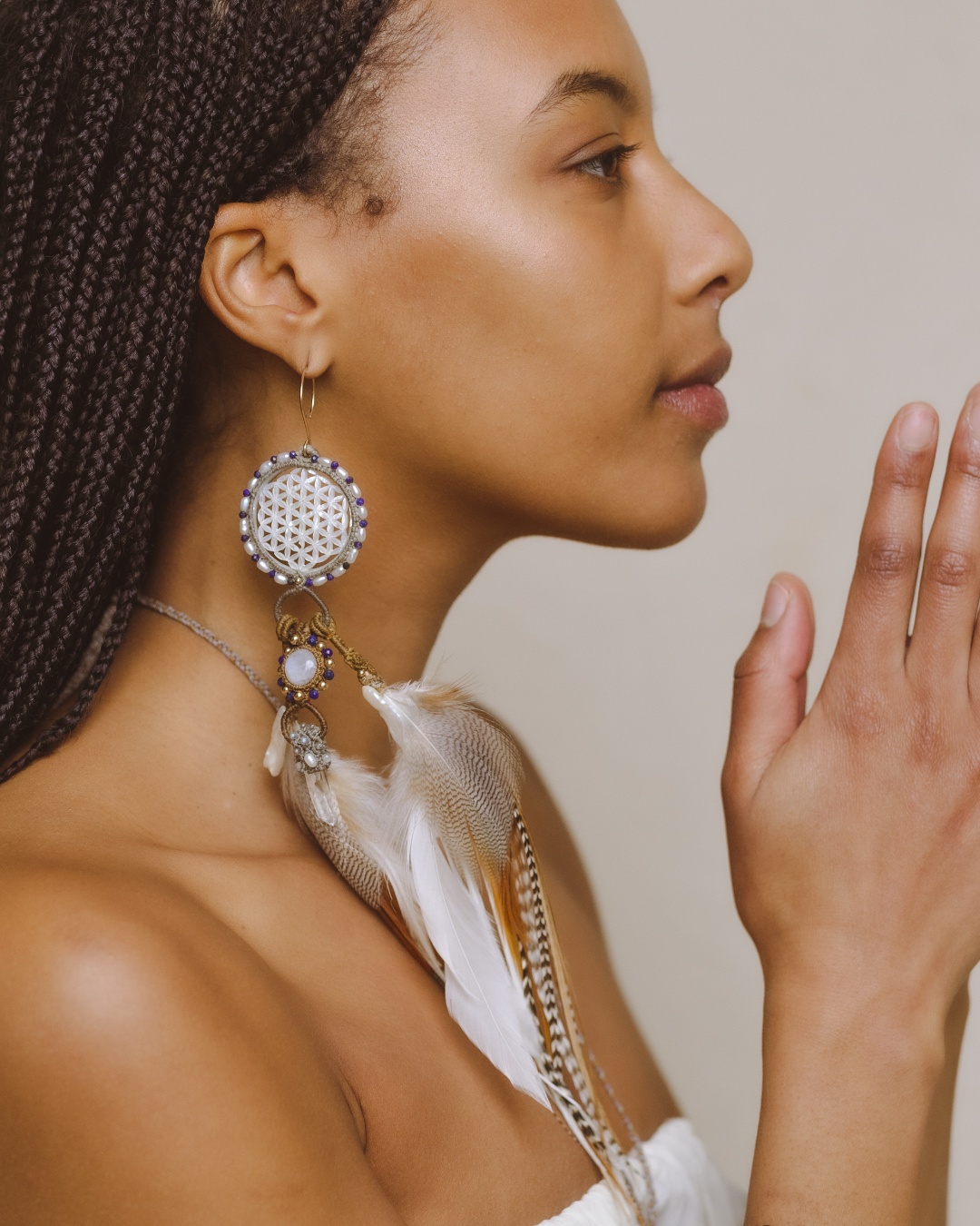 Side view of model wearing Feather Earrings – gemstones and precious metals, a masterpiece of love and intricate knots