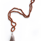 Rudraksha & Quartz 108 Meditation Mala. Handcrafted to align with your higher self, silk knots hold affirmations, enhancing your practice. Sacred Numerology adorned with healing gemstones; each piece includes a silk bag & guided meditation. Made to order for your awakening journey. Showing full length, on a white background.