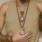 Rudraksha & Quartz 108 Meditation Mala. Handcrafted to align with your higher self, silk knots hold affirmations, enhancing your practice. Sacred Numerology adorned with healing gemstones; each piece includes a silk bag & guided meditation. Made to order for your awakening journey. On a model. 