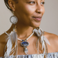 Front view of a model wearing Feather Earrings – a unique necklace with Spectrolite, Freshwater Pearl, Clear Quartz, Lapis, & Silver, opening hearts with love and intention.