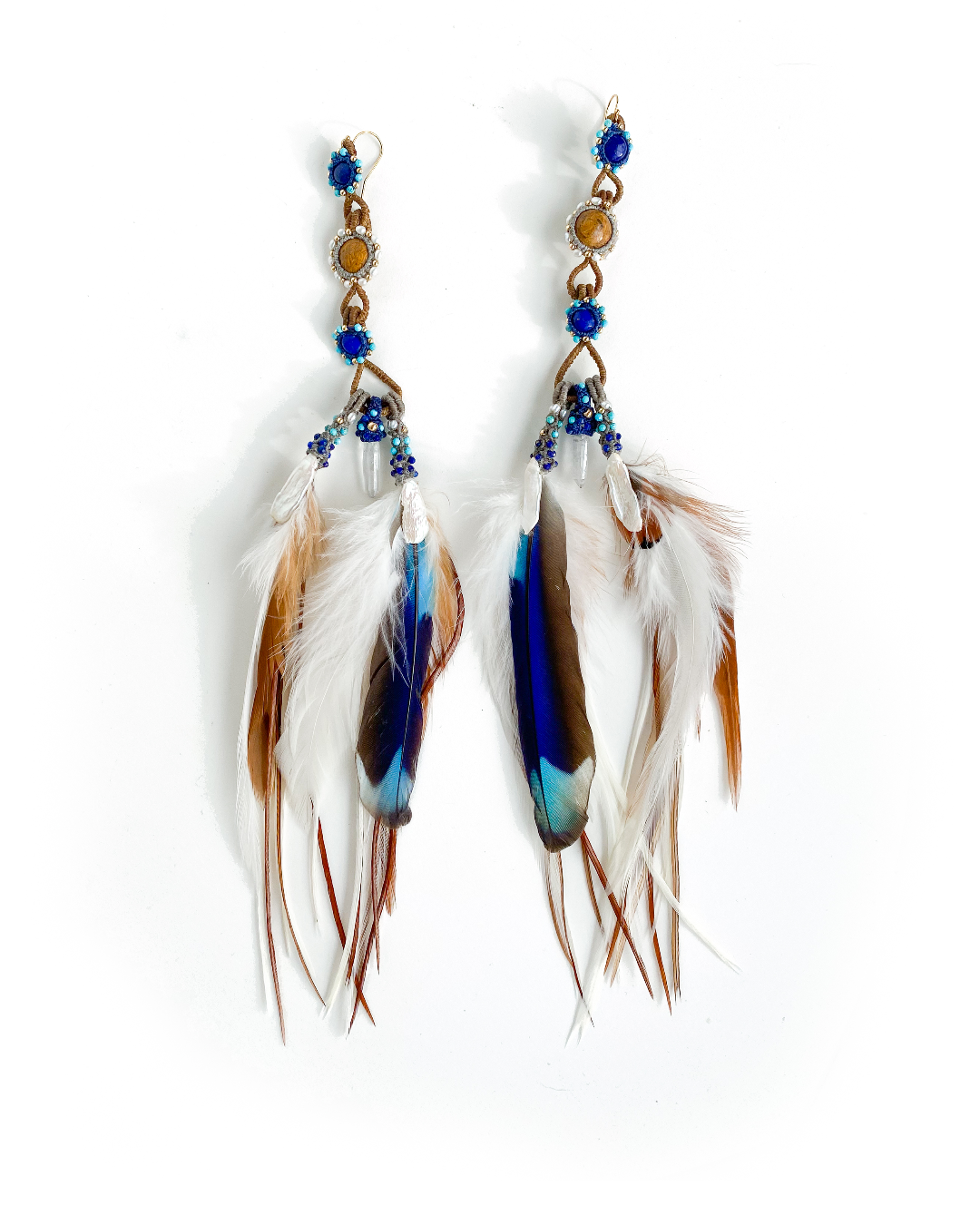 Feather Earrings on white background – clear quartz, Lapis, pearl & gold adornments, handcrafted with Flower of Life Sacred Geometry and cruelty-free Indian Roller feathers.